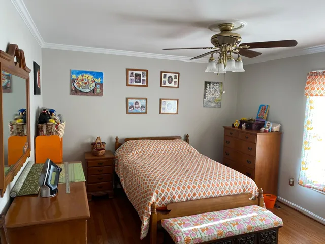 Guest bedroom cleaned with the bed made and linens smoothed
