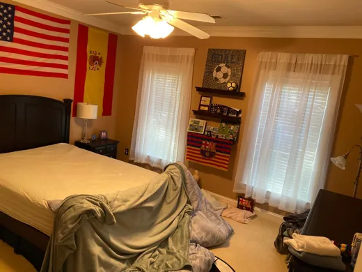 Bedroom refreshed with bed made and floor clear