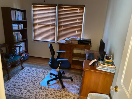 Home office bedroom cleaned with rug vacuumed