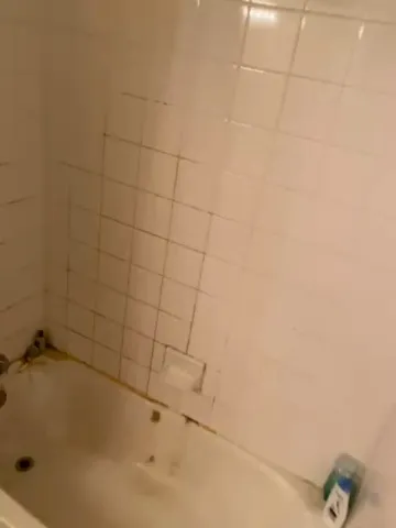 Tub before cleaning with heavy grime and mildew