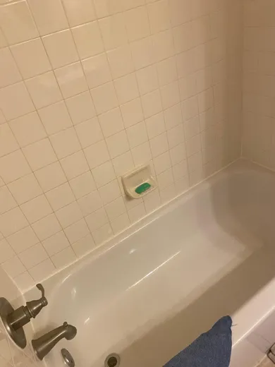 Bathtub wiped clean with fixtures polished