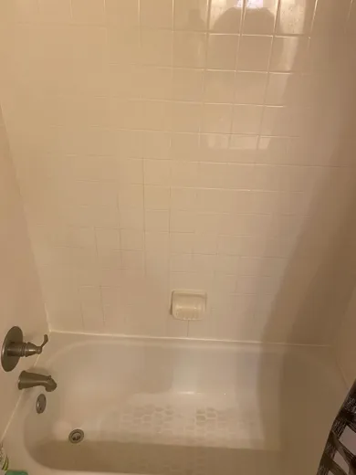 Tub surround tile cleaned to a shine