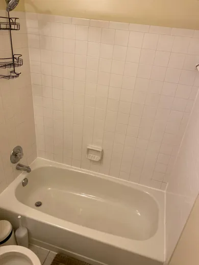 White bathtub cleaned with tile surround bright