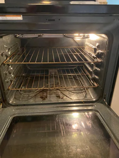 Oven interior cleaned with light showing clean walls