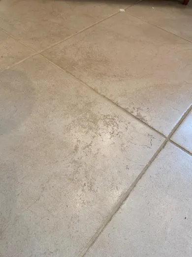 Tile floor grout before cleaning darkened by dirt