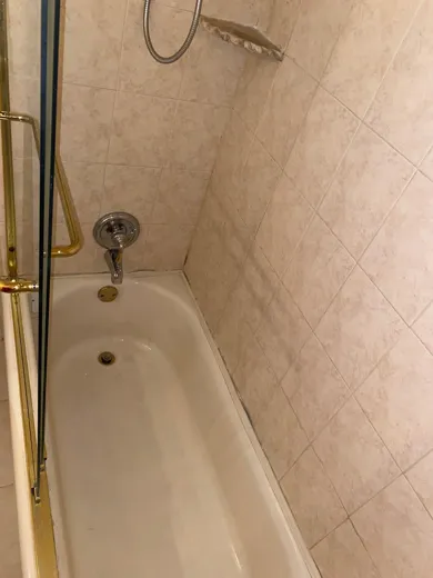 Tub with gold fixtures cleaned and polished